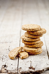 Image showing Fresh oat cookies on rustic wooden table background. 