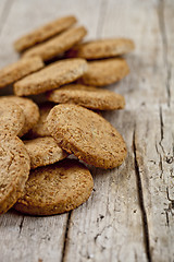 Image showing Fresh oat cookies on rustic wooden table background.