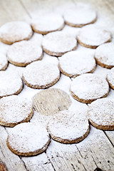 Image showing Fresh baked oat cookies with sugar powder on rustic wooden table