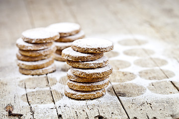 Image showing Fresh oat cookies with sugar powder on rustic wooden table backg