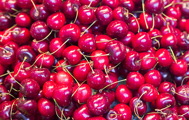 Image showing Pile of ripe red fresh cherries as background