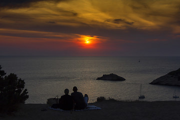 Image showing Young couple looking at the sea at sunset