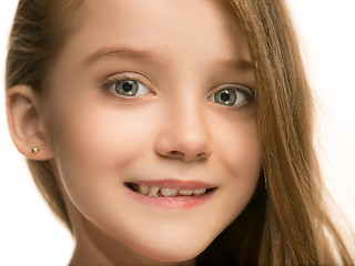 Image showing The happy teen girl standing and smiling against white background.