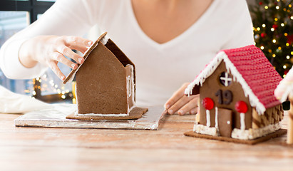 Image showing close up of woman making gingerbread houses