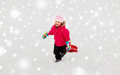 Image showing little girl with sled on snow hill in winter