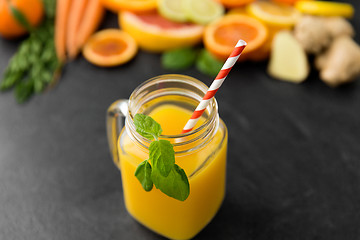 Image showing mason jar glass of fruit juice on slate table top