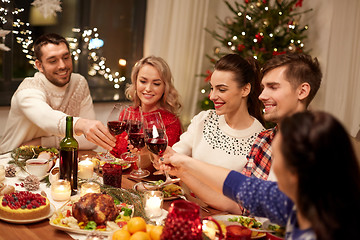 Image showing friends celebrating christmas and drinking wine