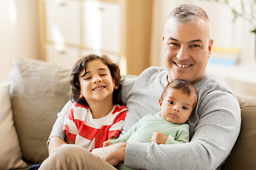 Image showing happy father with preteen and baby son at home