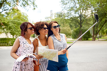 Image showing women with city guide and map taking selfie