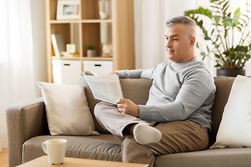 Image showing man reading newspaper at home