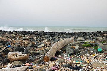 Image showing Spilled garbage on the beach near the big city. Empty used dirty plastic bottles and other garbage. Environmental pollution. Ecological problem.