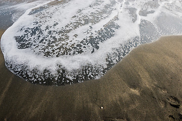 Image showing Beautiful soft wave on black sand at the sea