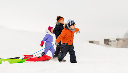 Image showing happy little kids with sleds in winter