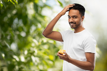 Image showing indian man applying hair wax or styling gel