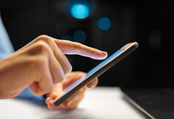 Image showing close up of hands with smartphone at night office