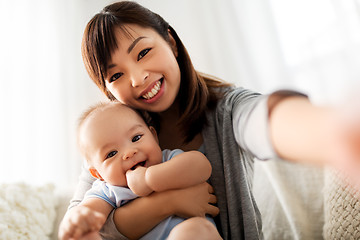 Image showing happy mother with little baby son taking selfie