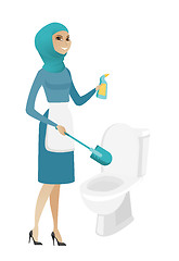 Image showing Muslim cleaner in uniform cleaning toilet bowl.