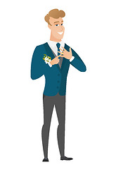 Image showing Cheerful groom showing golden ring on his finger.