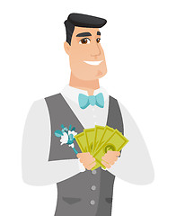 Image showing Young caucasian groom holding money.