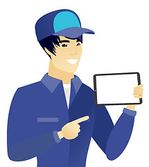 Image showing Young asian mechanic holding tablet computer.