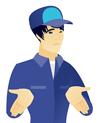 Image showing Young asian confused mechanic shrugging shoulders.