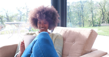 Image showing african american woman at home using digital tablet