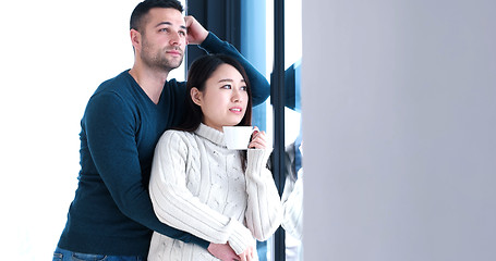 Image showing multiethnic couple relaxing at modern home indoors