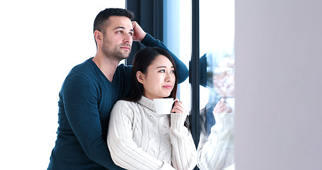 Image showing multiethnic couple relaxing at modern home indoors