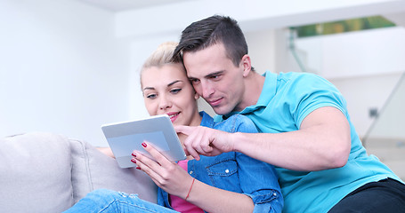 Image showing couple relaxing at  home with tablet computers