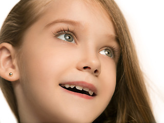 Image showing The happy teen girl standing and smiling against white background.