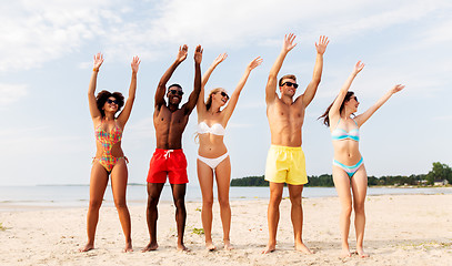 Image showing happy friends having fun on summer beach