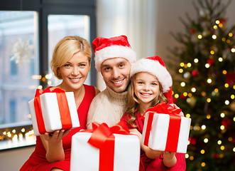 Image showing happy family with christmas gifts at home