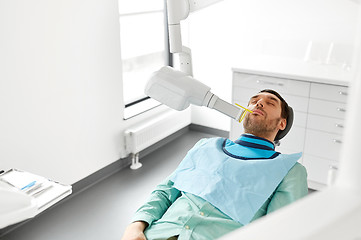 Image showing patient having x-ray scanning at dental clinic
