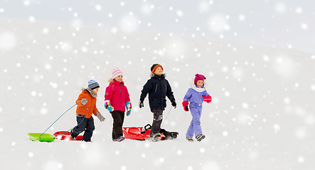 Image showing happy little kids with sleds in winter