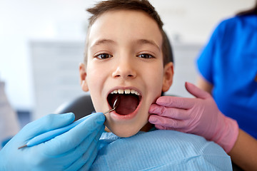 Image showing boy having teeth checkup at dental clinic