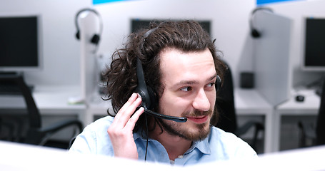 Image showing male call centre operator doing his job