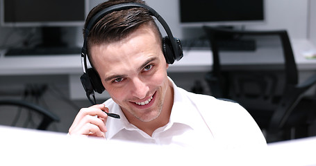 Image showing male call centre operator doing his job