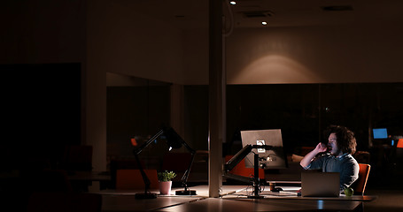 Image showing man working on computer in dark office