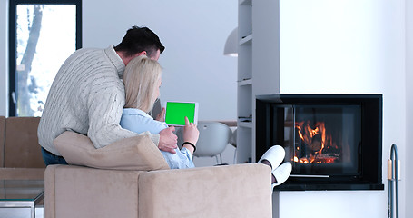 Image showing couple relaxing at  home with tablet computers