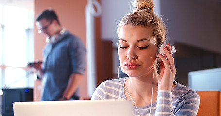 Image showing businesswoman using a laptop in startup office