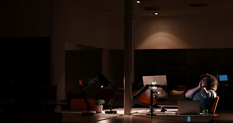 Image showing man working on computer in dark office