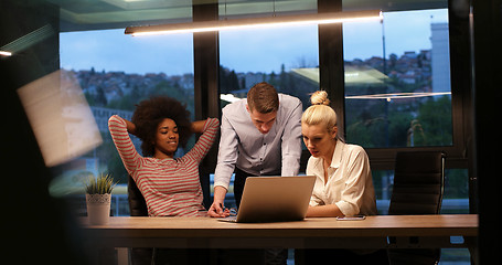 Image showing Multiethnic startup business team in night office