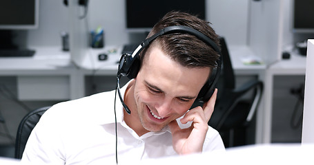 Image showing male call centre operator doing his job