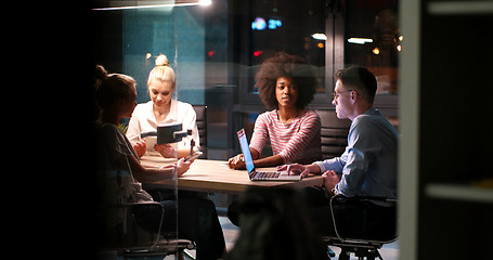 Image showing Multiethnic startup business team in night office