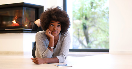 Image showing black women using tablet computer on the floor