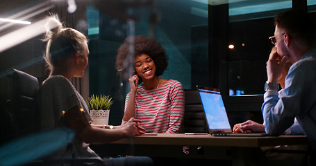 Image showing Multiethnic startup business team in night office