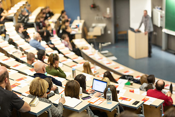 Image showing Expert speaker giving a talk at scientific business conference event.