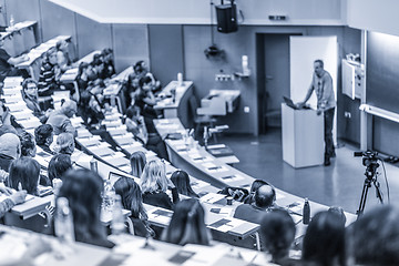 Image showing Expert speaker giving a talk at scientific business conference event.