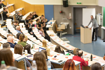 Image showing Expert speaker giving a talk at scientific business conference event.