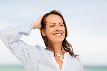 Image showing happy smiling woman on summer beach